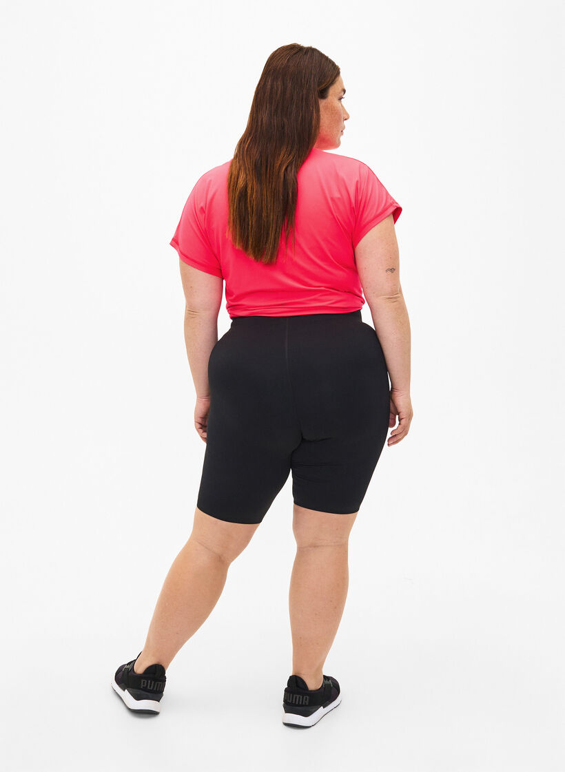 Tettsittende treningshorts med lomme, Black, Model image number 1