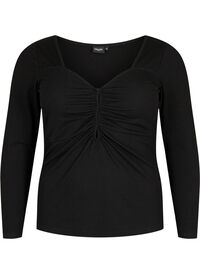 Bluse i ribbestrikk med hull som detalj