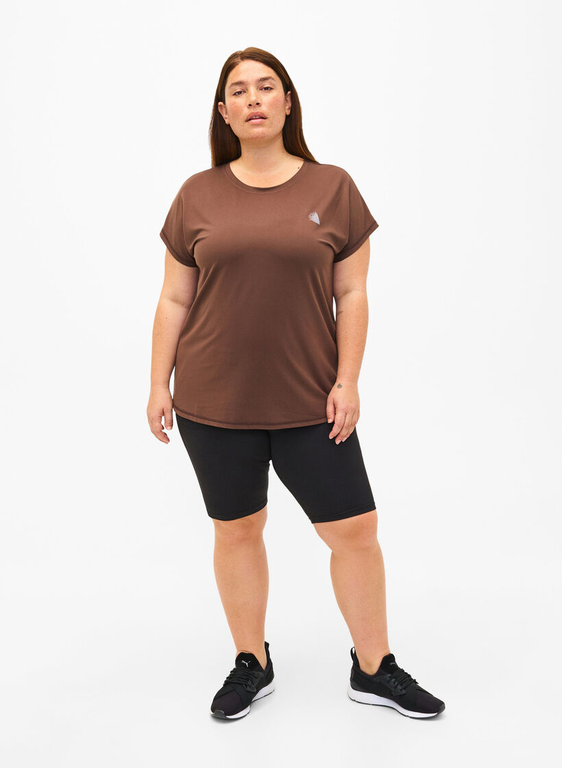 Tettsittende treningshorts med lommer, Svart, Model image number 1